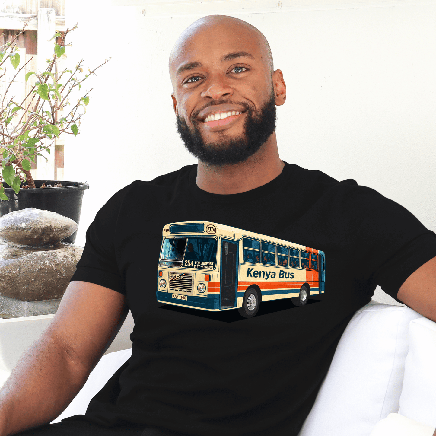 Man wearing a black t-shirt with a Kenya bus made by marto and t-shirts