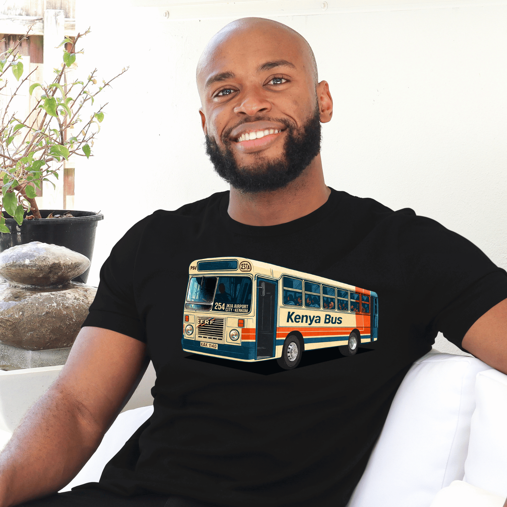 Man wearing a black t-shirt with a Kenya bus made by marto and t-shirts